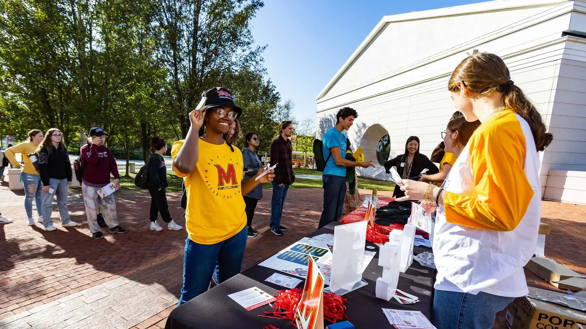 Students outside of Riggs Alumni Center in line outside during a tabling event