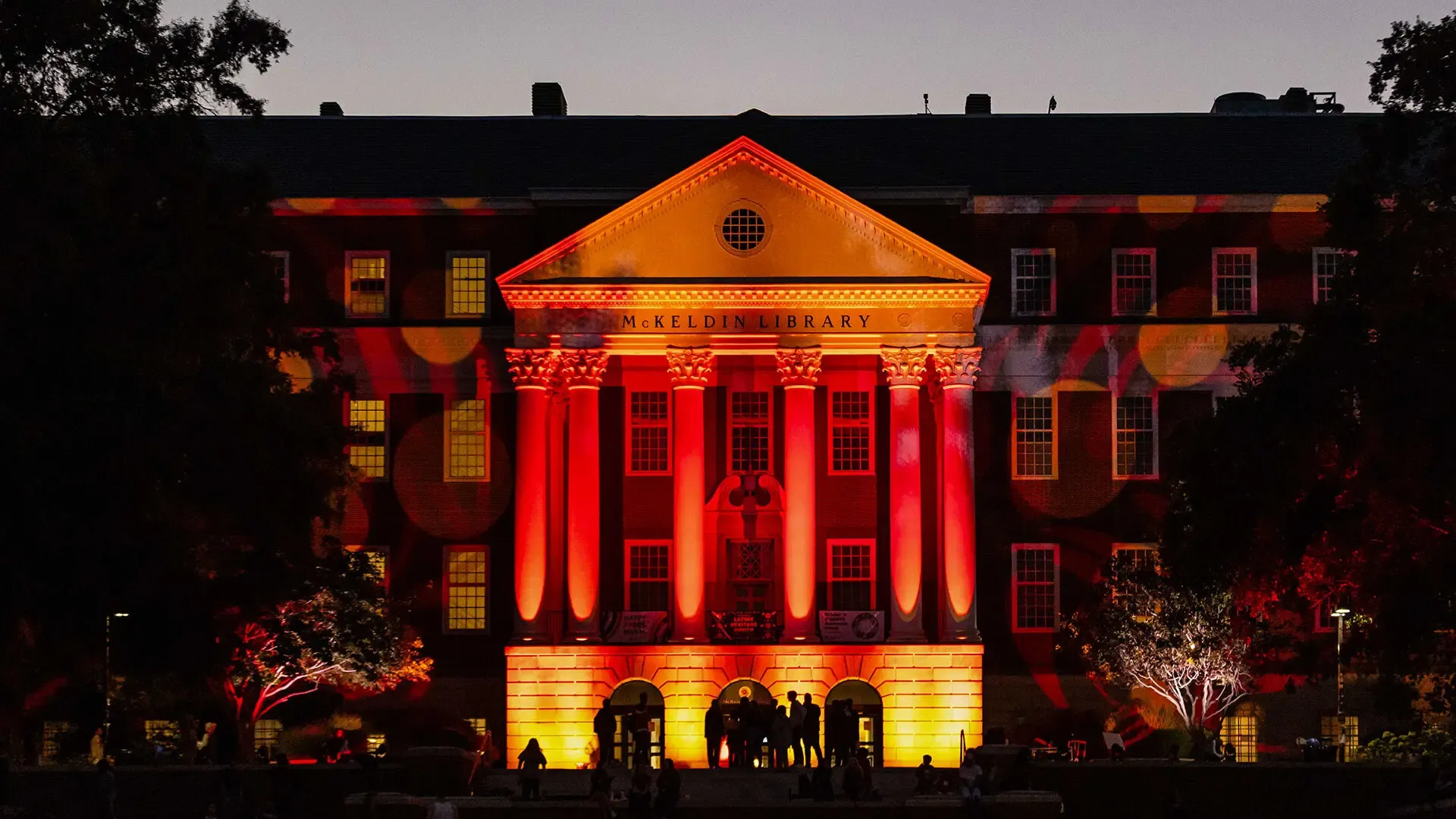 Homecoming themed color lights reflected on mckeldin library