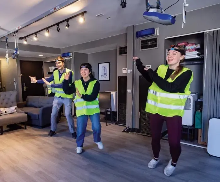 Researchers and students from Milton’s lab test technology used to track participants in the flu study’s common room by playing a dancing video game.