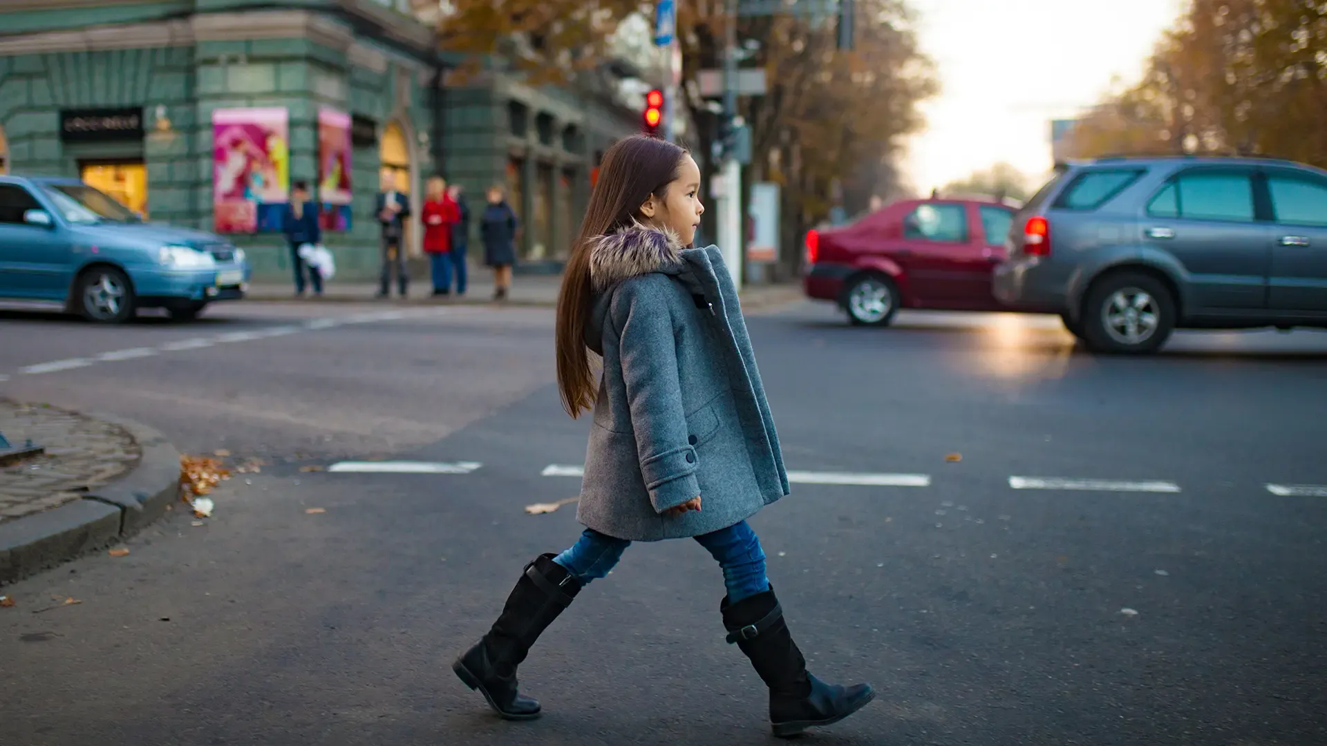 little girl crossing busy city street