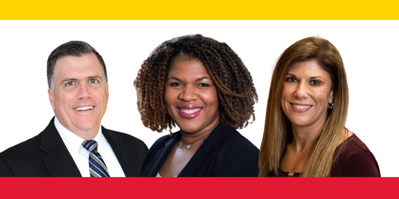 Three faculty smile to camera with yellow and red bands