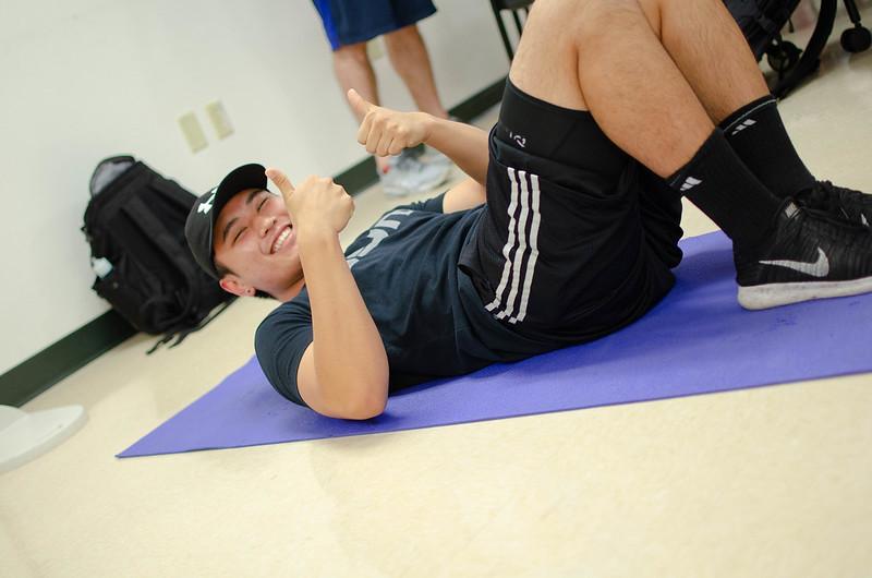 Student completing a crunch with a thumbs up