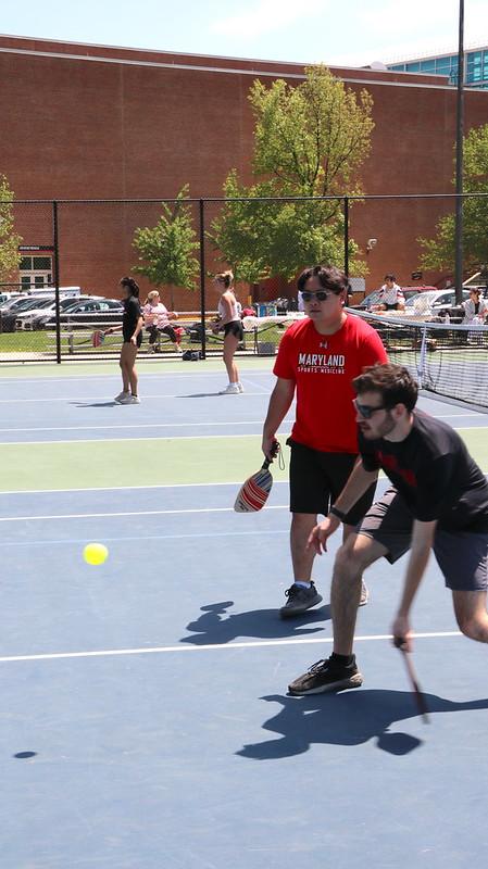 Two students playing pickleball