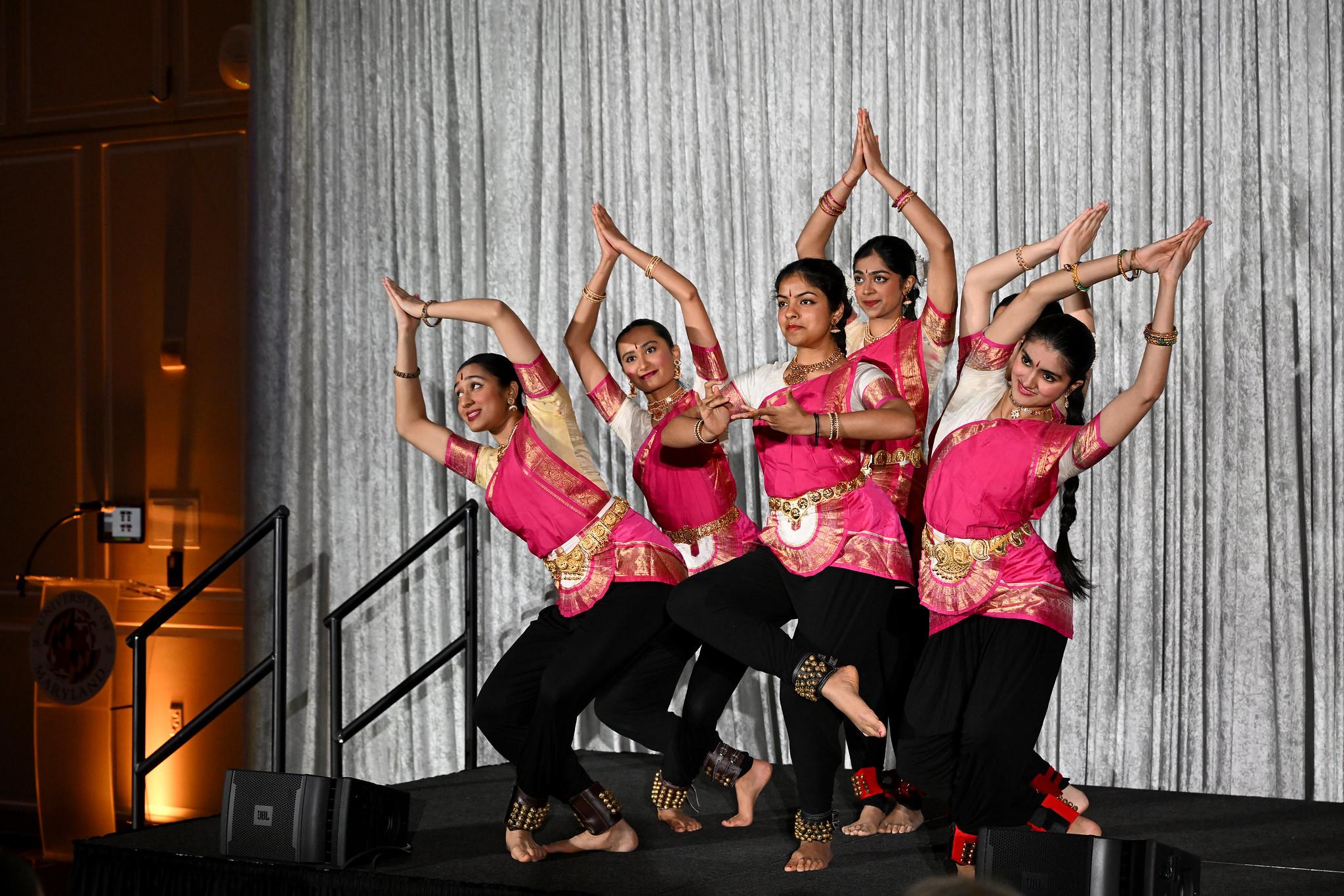 classical indian dance troupe dancing on stage