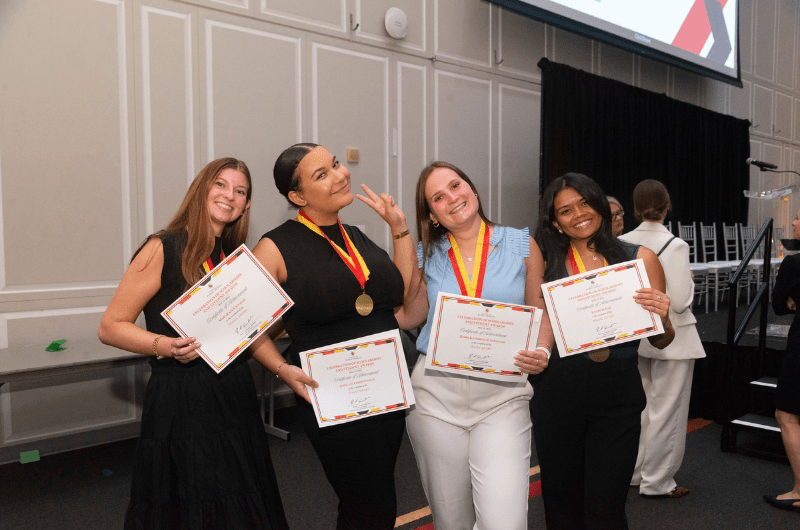 students posing with their awards