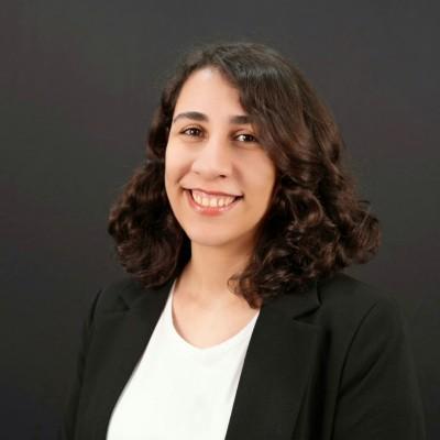 Picture of Sarah Azizi, CARES Lab Coordinator, smiling person with dark, curly hair