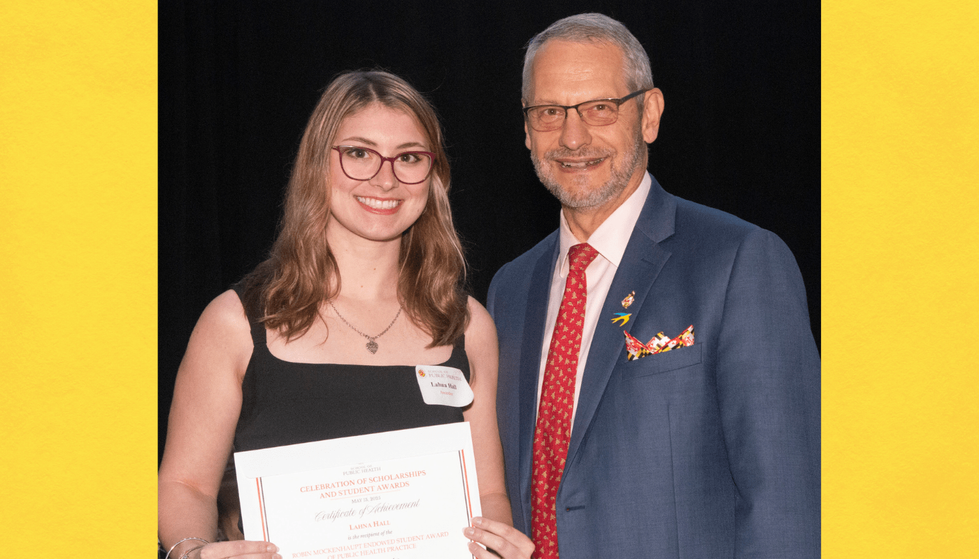 Female student posing with award certificate