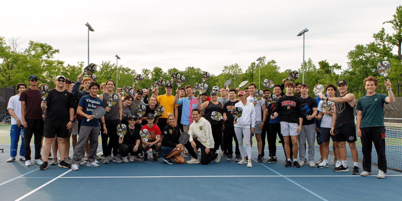 Group of students posing on pickleball court