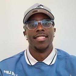 smiling black male student headshot with glasses and a grey hat