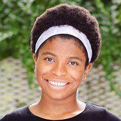 smiling black female student headshot with short hair and white bandana