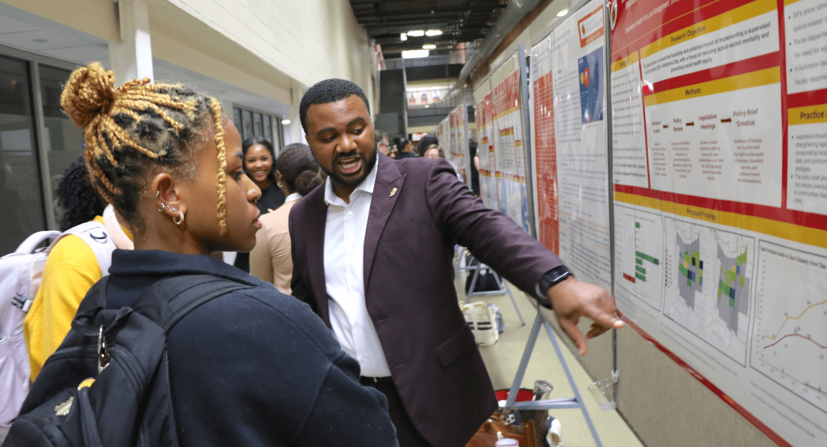 Man showing graphs to woman
