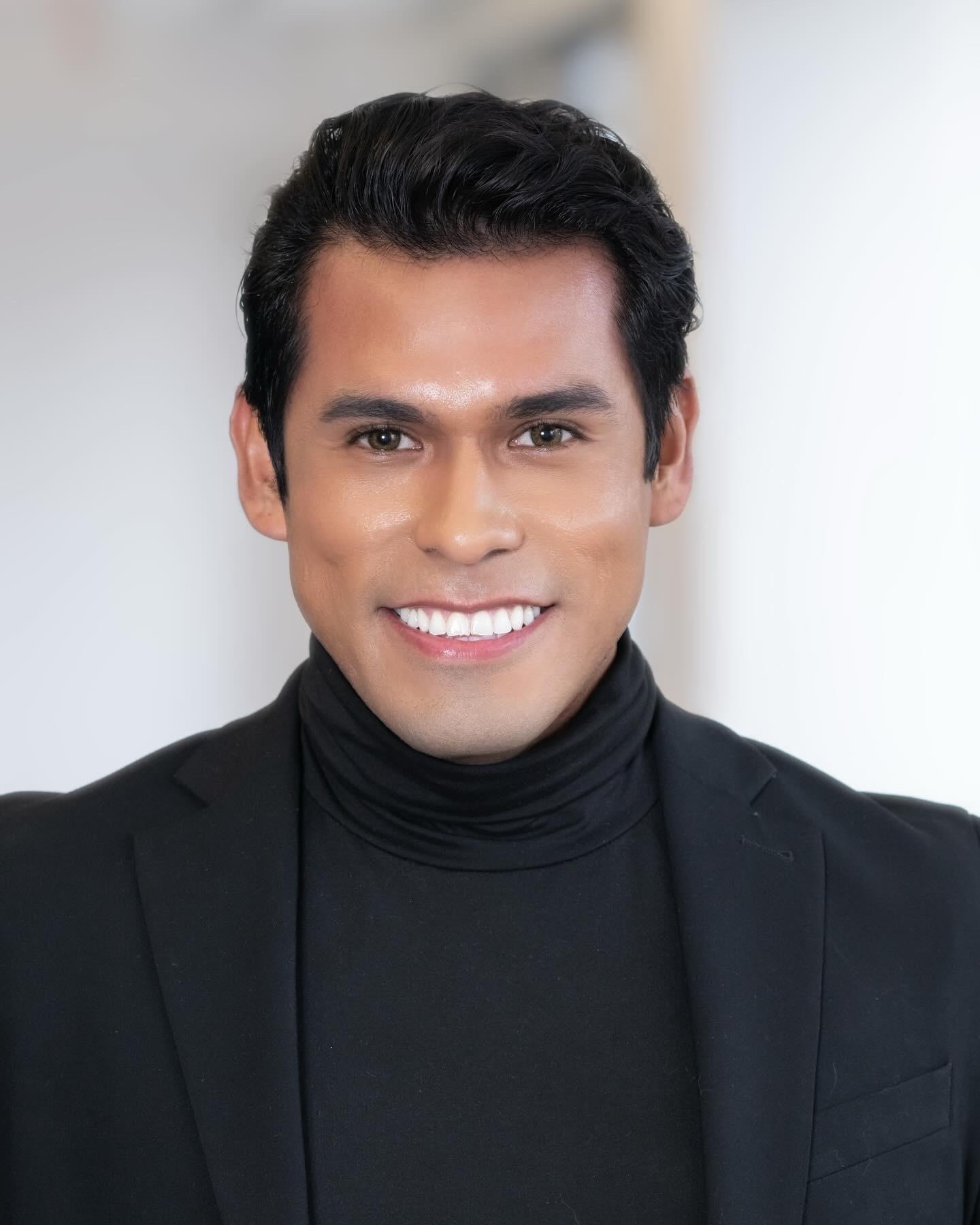 man in black turtle neck and blazer