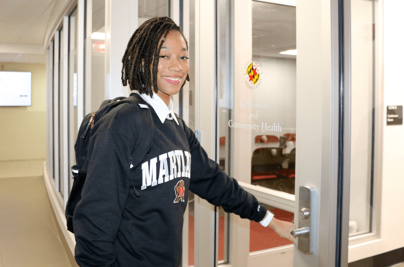 Black female student wearing UMD sweatshirt