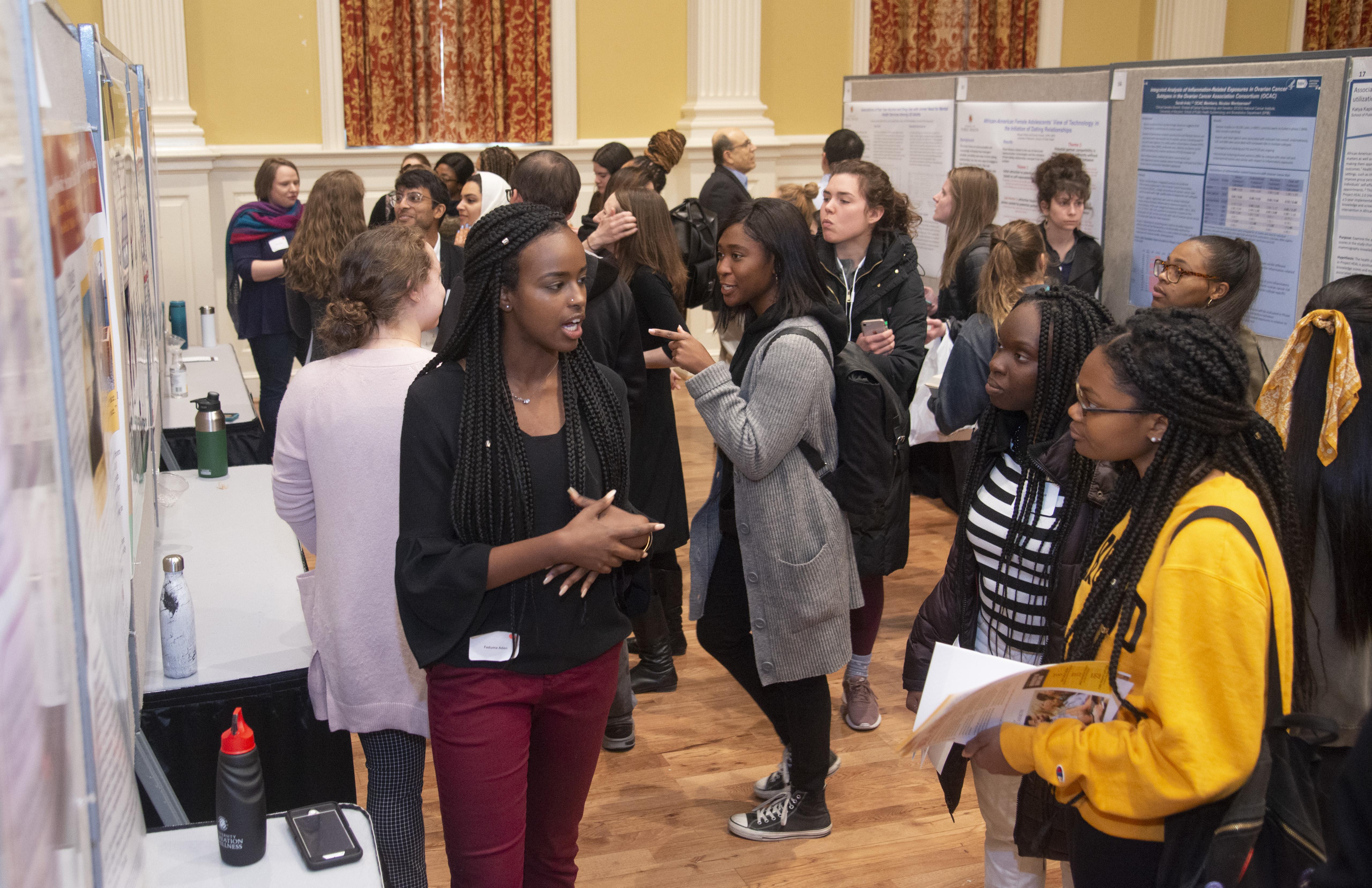 female student explaining her poster presentation