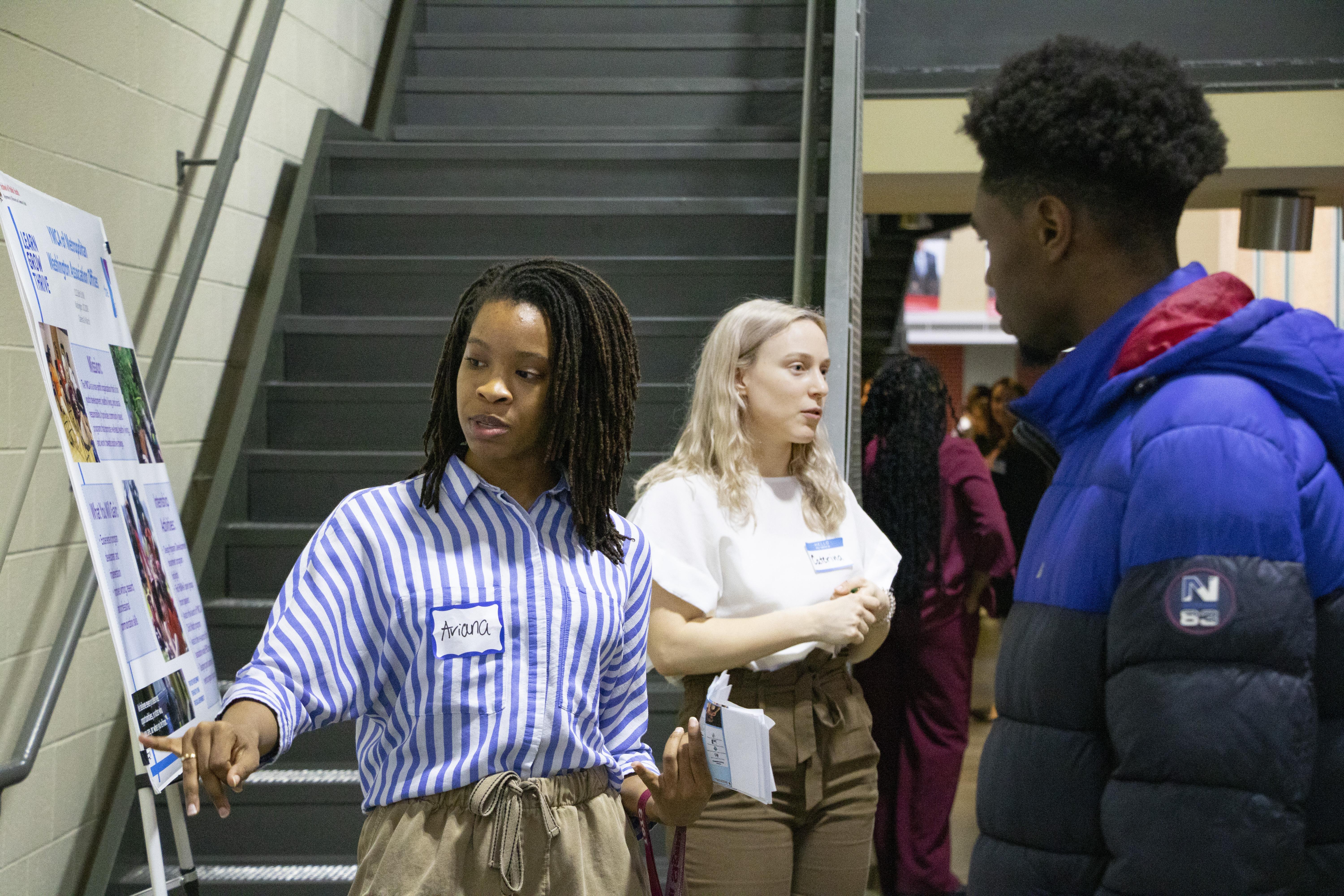 female student explaining her poster presentation