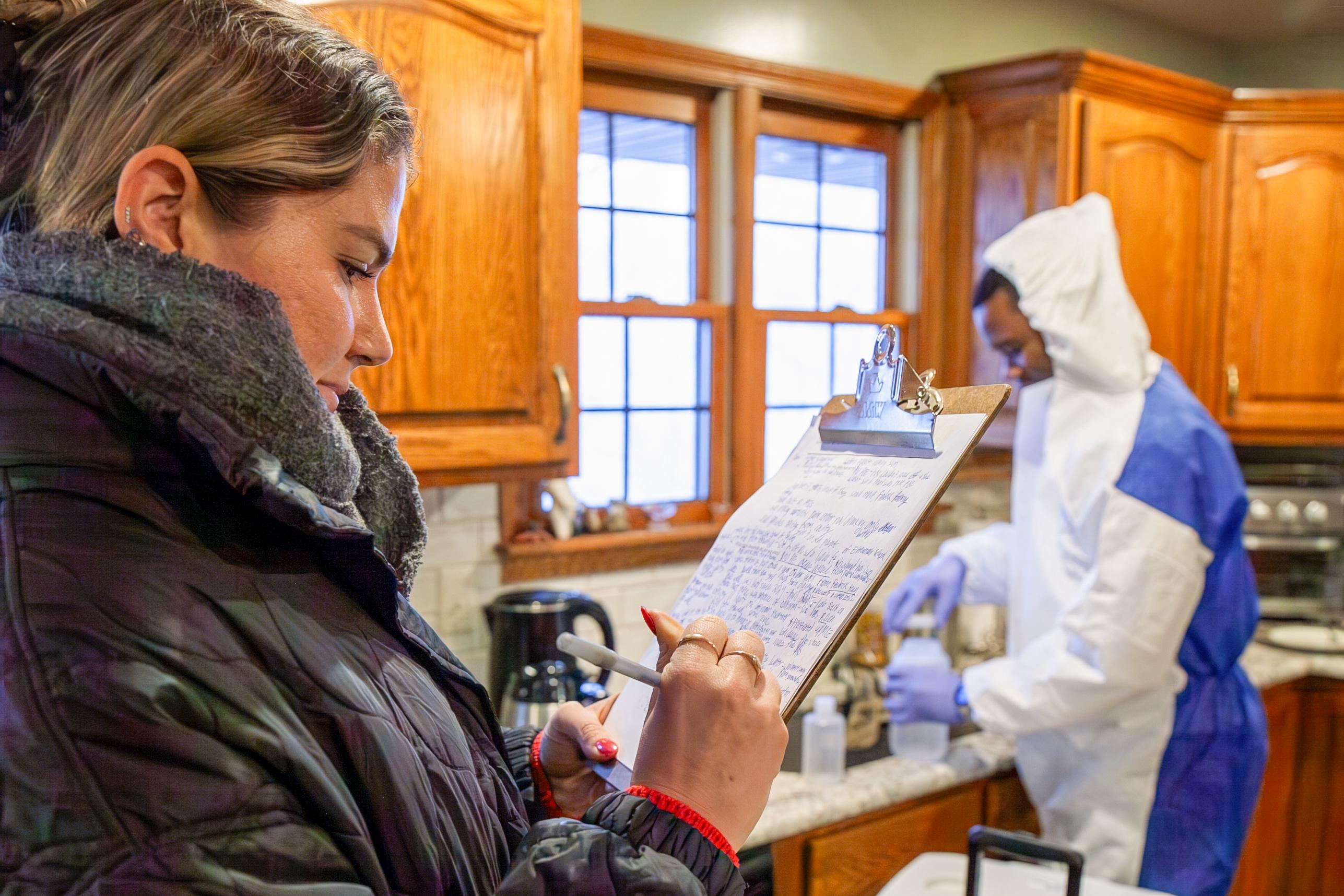 Researchers take information and water samples in a residential kitchen