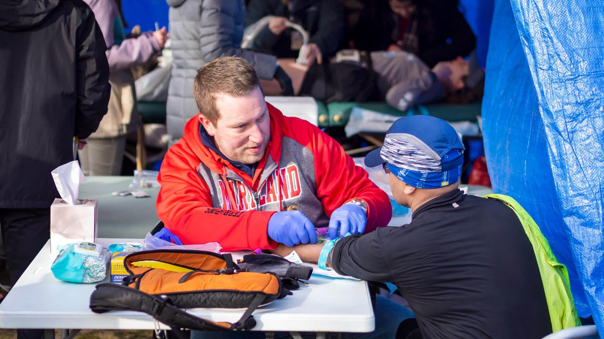 Photograph of Dr. Prior interacting with an ultramarathon participant