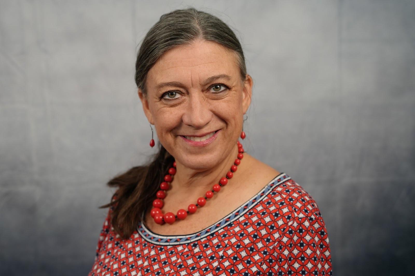 Woman with long hair in a ponytail wearing red