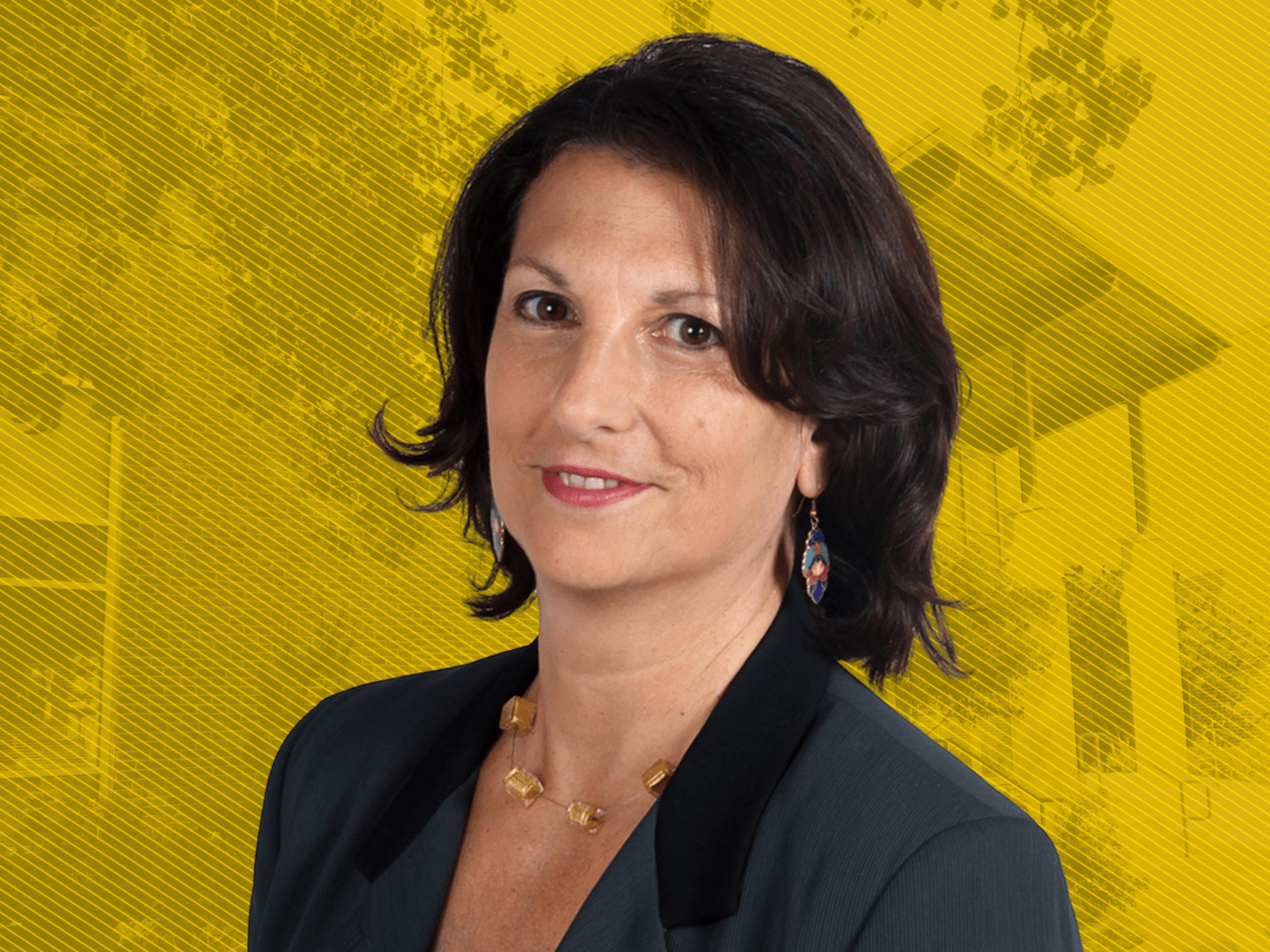 Headshot of woman with dark brown hair and dark suit with small smile, in front of yellow graphic background showing a building and trees