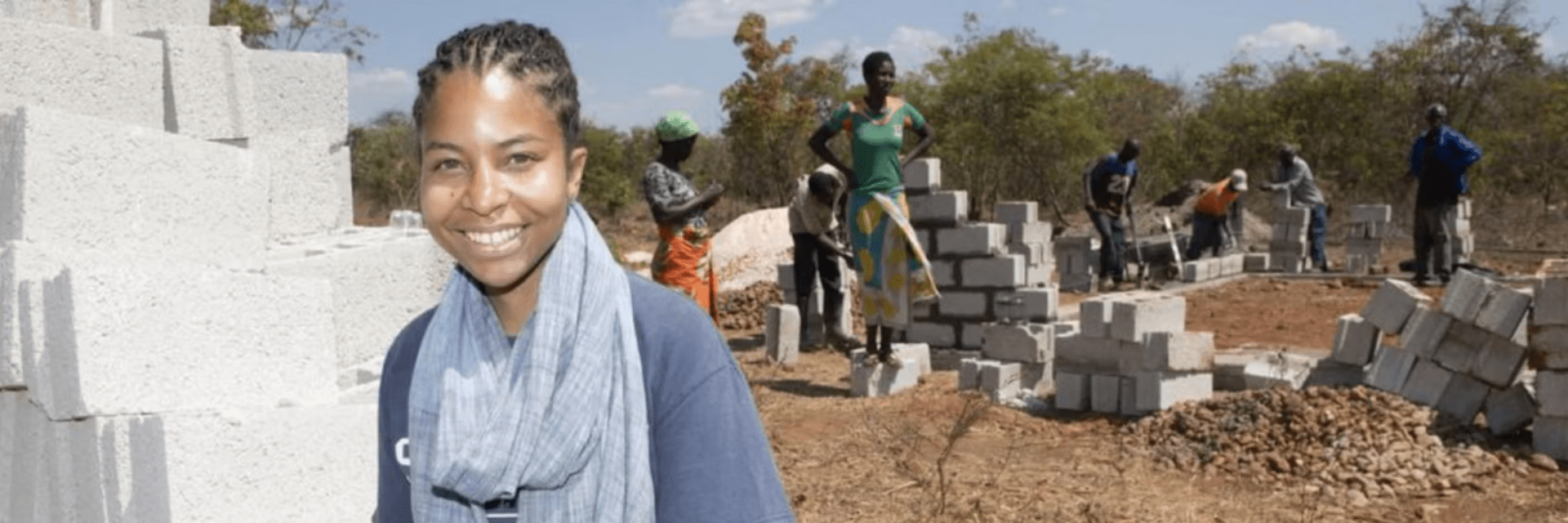 Smiling woman in front of construction site.
