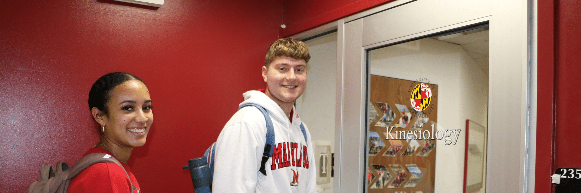 two students about to open the door to the department of kinesiology