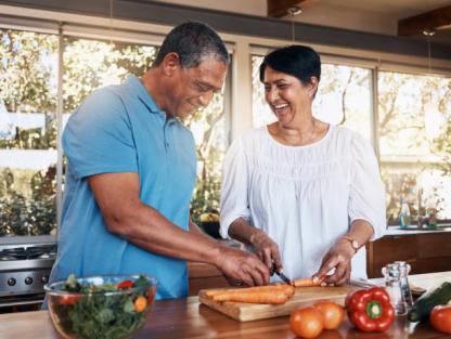 Mature, couple and healthy cooking in kitchen to chop vegetables for salad diet, nutrition and lunch meal at home. 