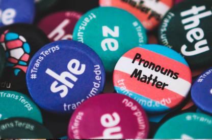 Buttons saying "Pronouns Matter" and listing pronouns like "she and "ze"